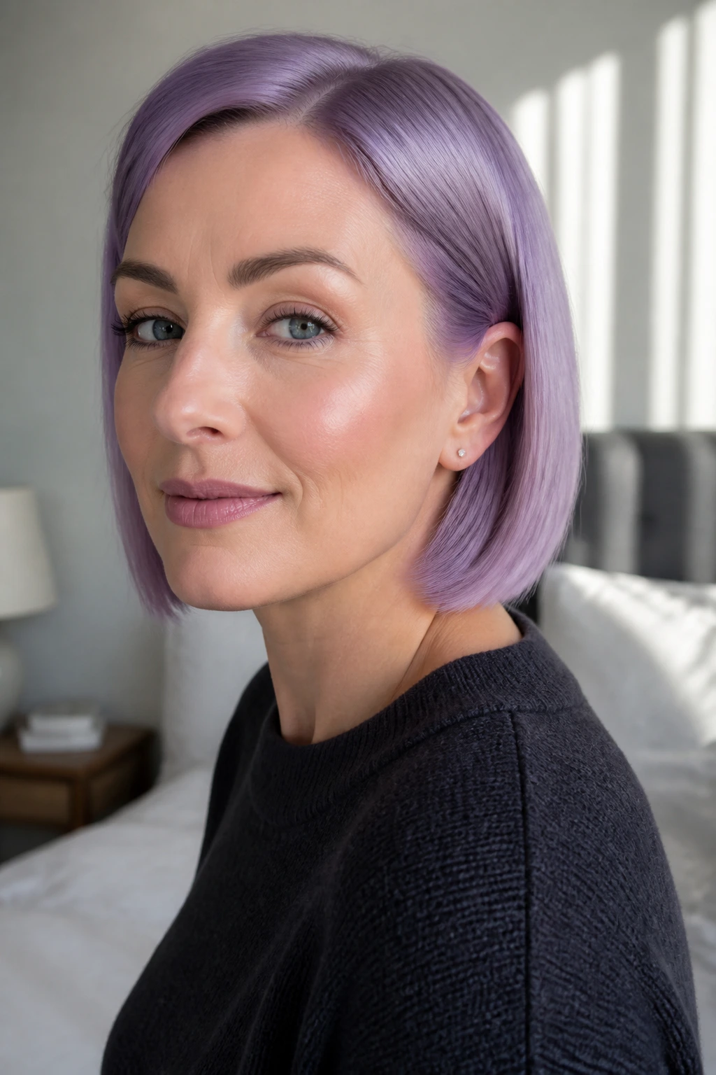 Close-up of a real woman with a frosted violet bob in natural light.