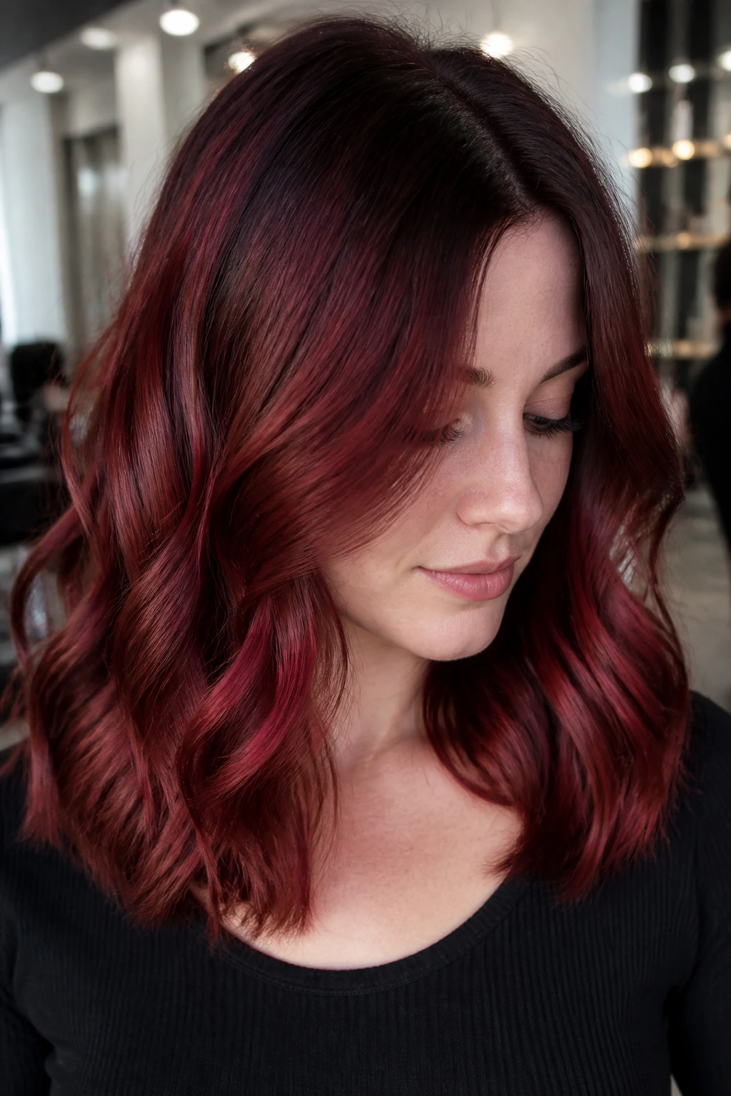 Close-up of garnet root shadow hair color on a real woman