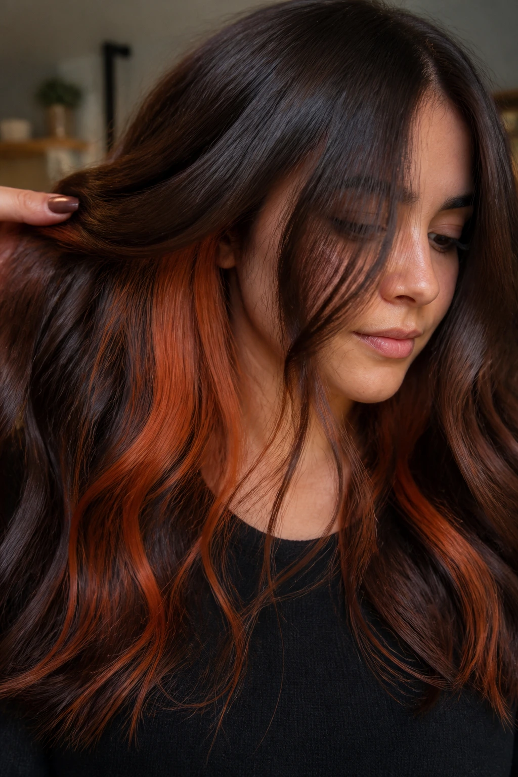 Real person showing ginger peekaboo underlayers beneath brown hair