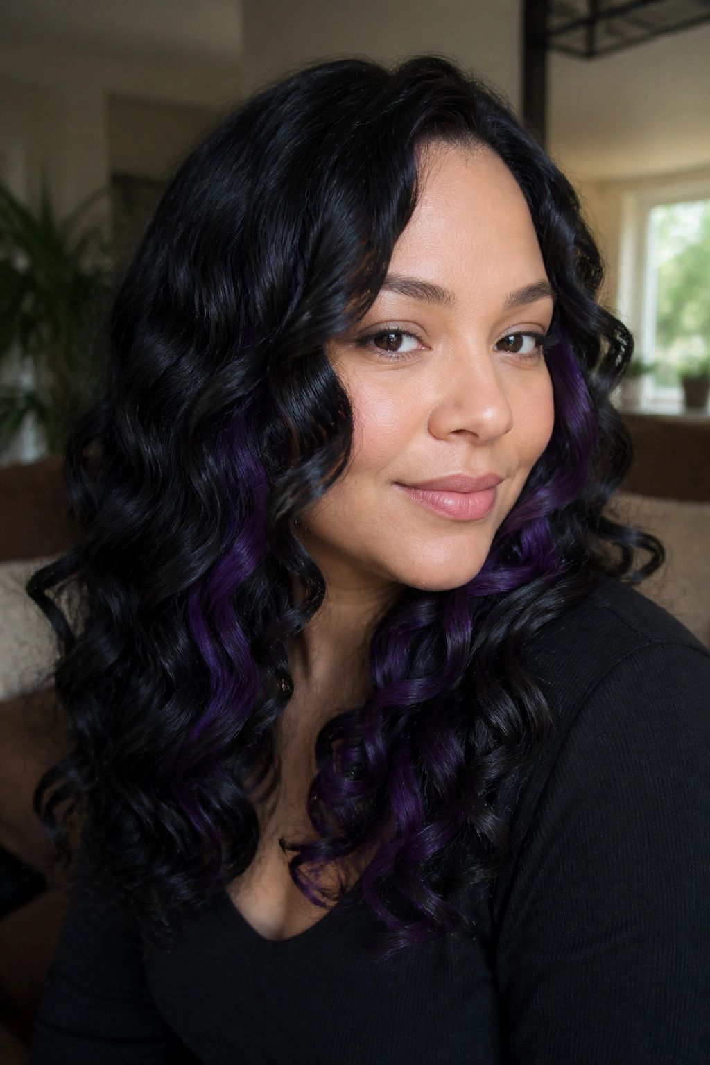Close-up of a real woman with glossy black curls and purple peekaboo panels peeking from under the top layer