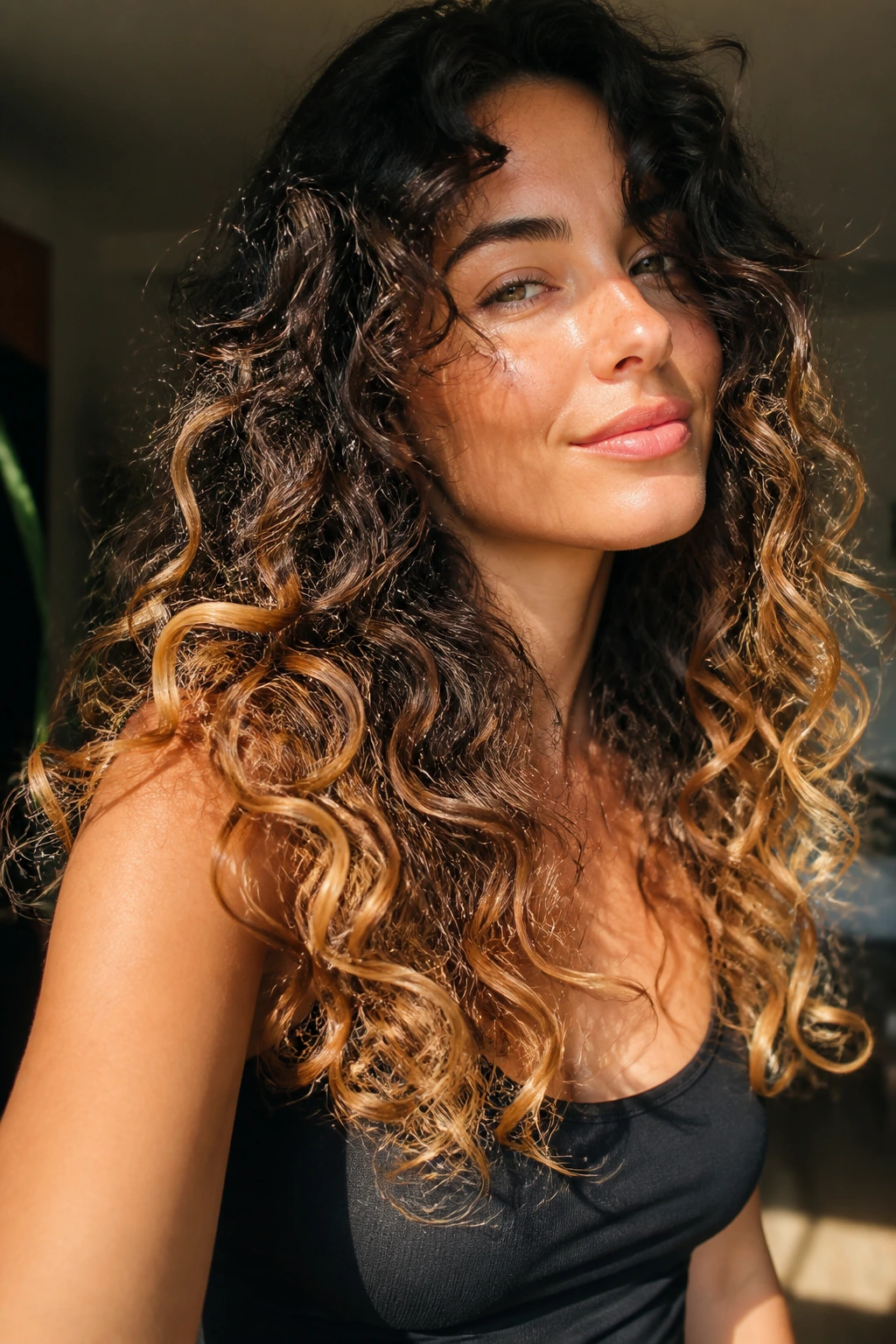 Long layered curls with golden ends catching sunlight