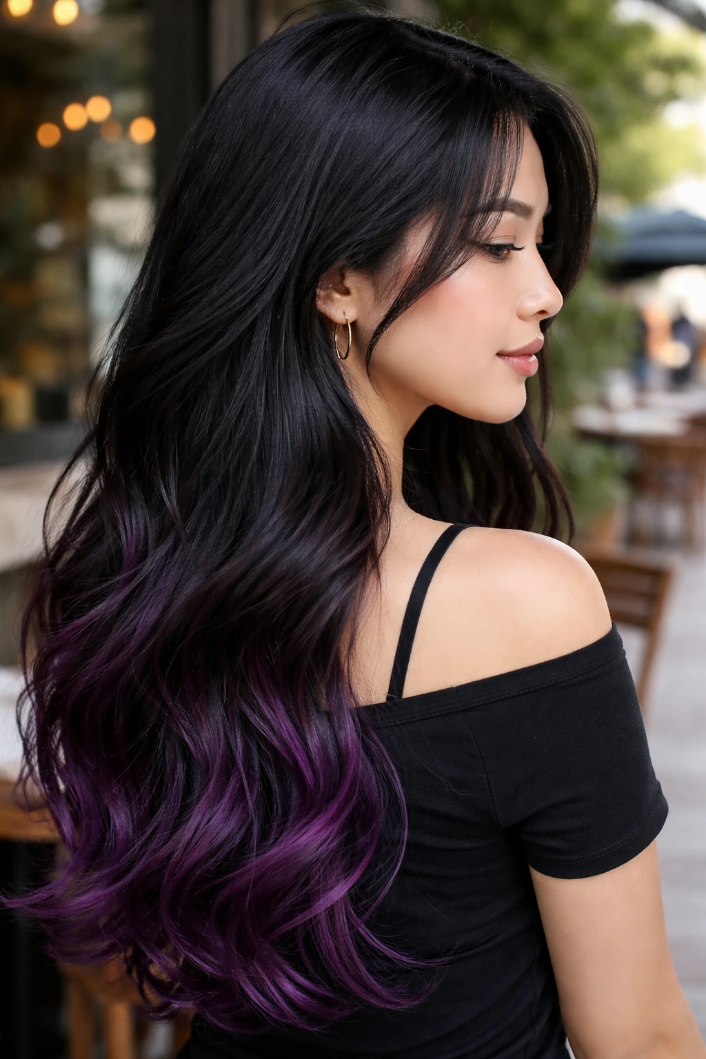 Profile of a real woman with black hair showing dark grape gradient tips