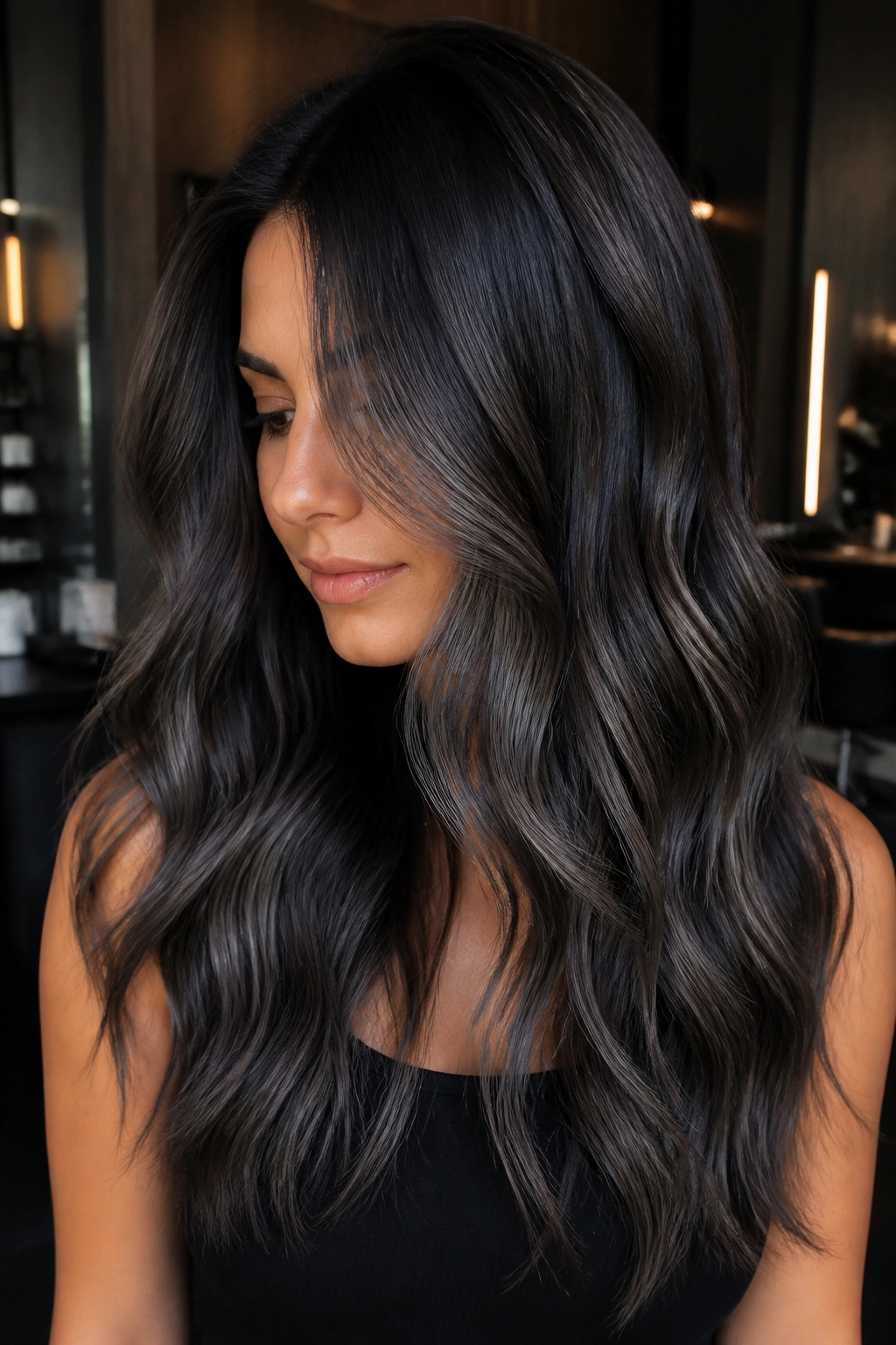 Close-up of a real woman with graphite balayage on espresso hair
