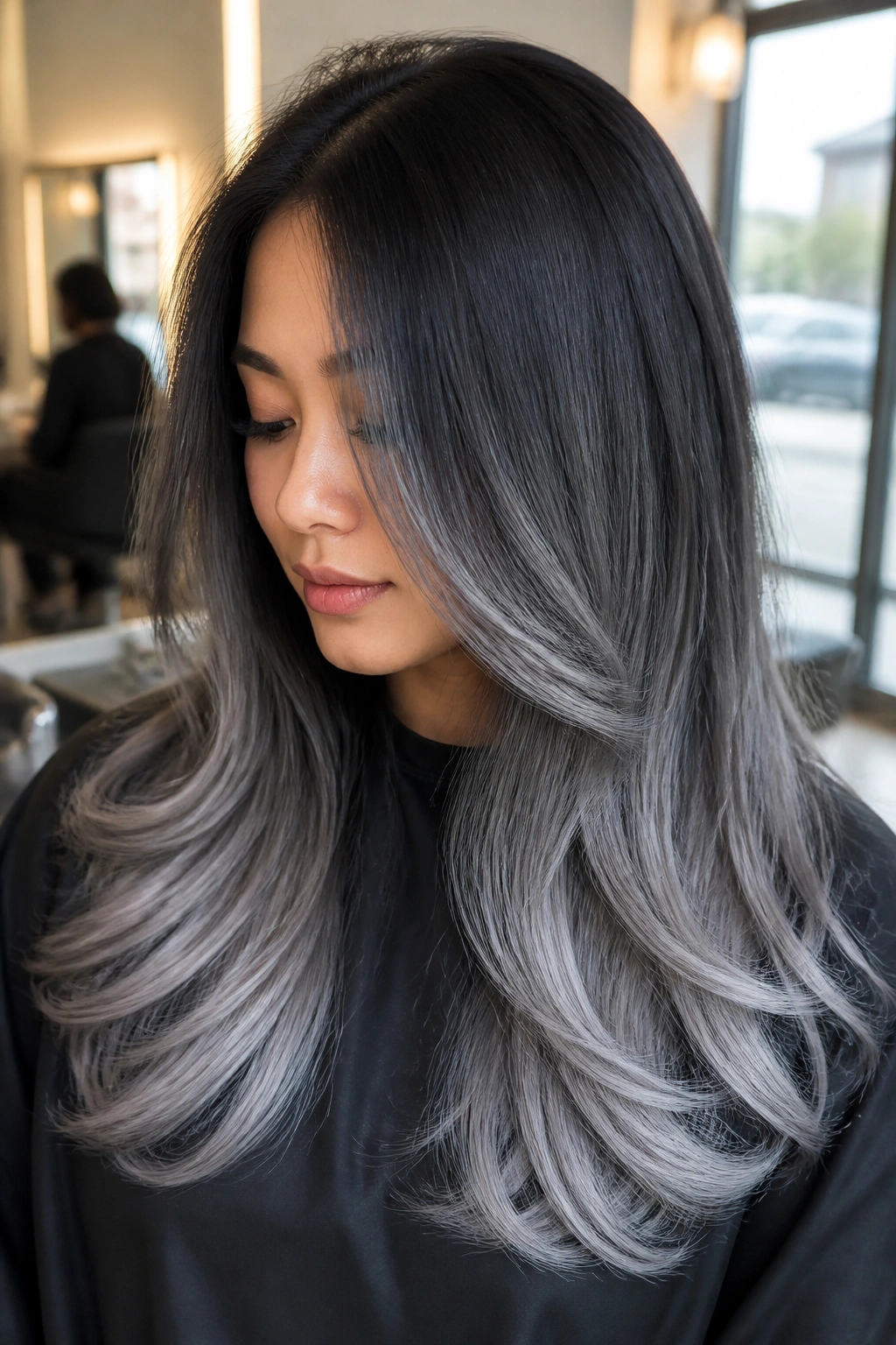Close-up of long layered hair with graphite to silver ombre