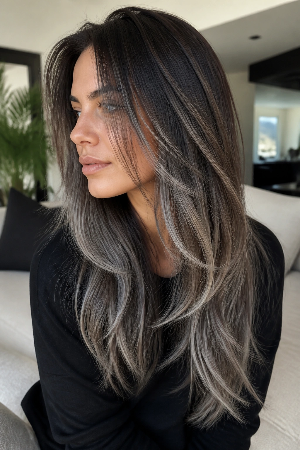 Real person with long layered brown hair featuring grey balayage