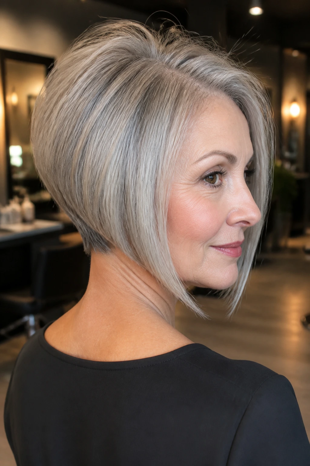 Portrait of a real woman with inverted bob and crown volume in a stylish salon