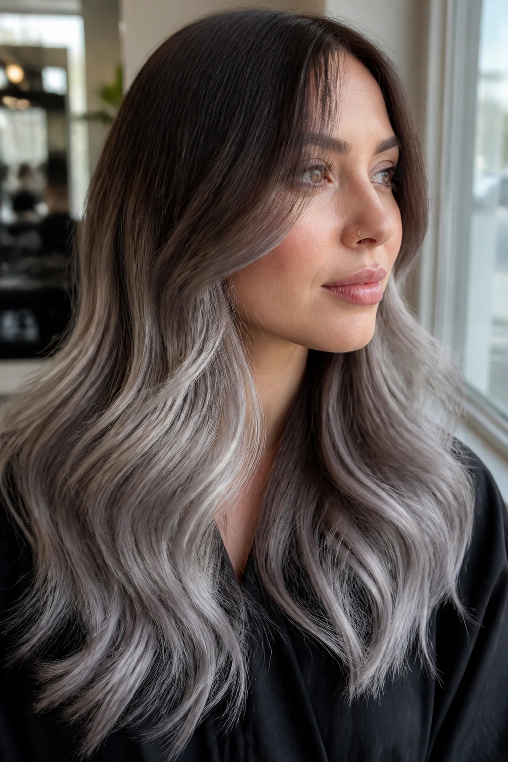 Portrait of a person with grey ombré and brown root shadow on long hair