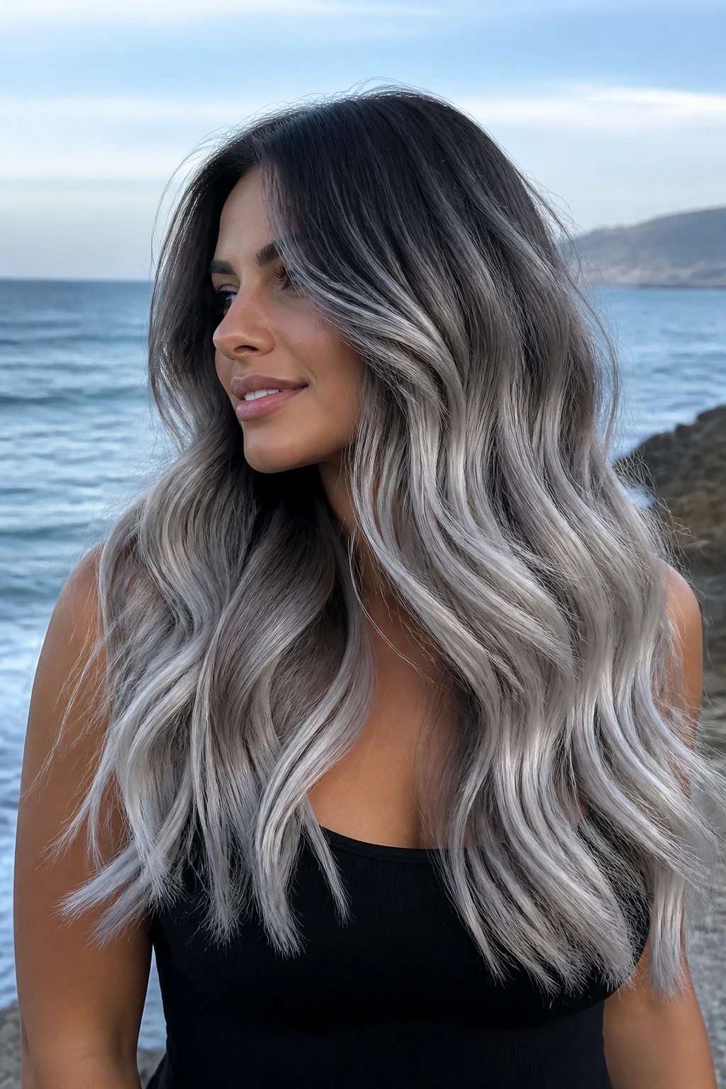 Mid-shot of long hair in gunmetal to silver waterfall waves on a real person