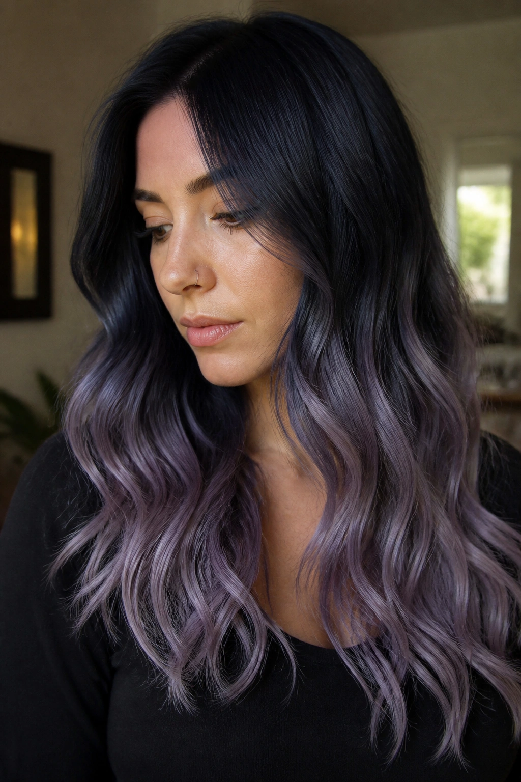 Close-up portrait of a real woman with blue-black to lavender smoke hair.