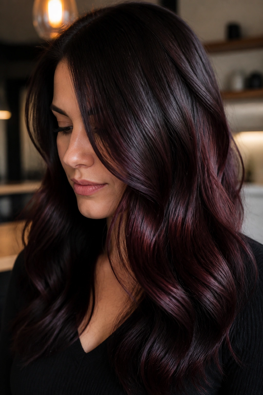 Portrait of dark chocolate hair with cabernet glaze in warm indoor light