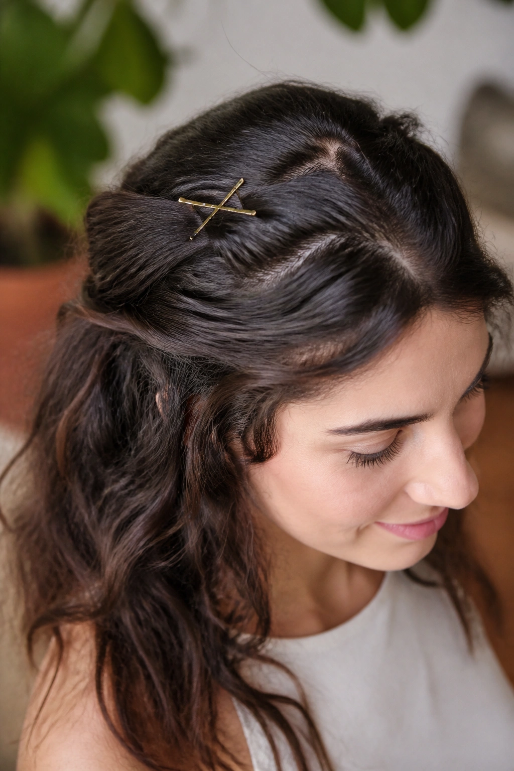 Close-up of a real woman wearing a half-up twist crown with twisted sections