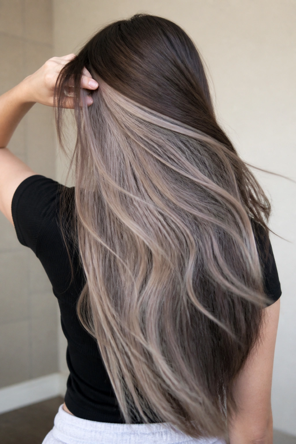 Back view of long hair revealing hidden ash ombre underneath