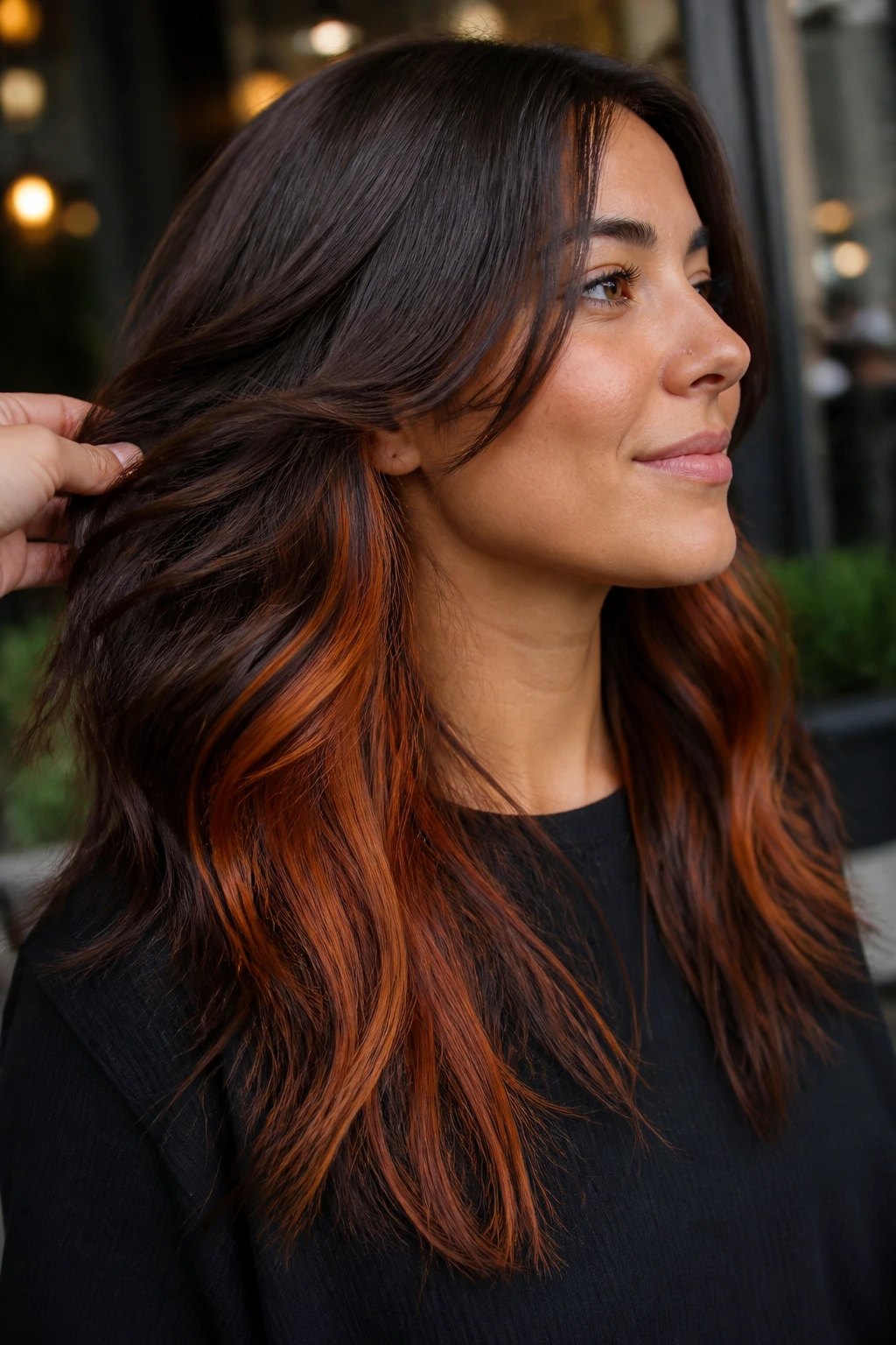 Close-up of a real woman revealing hidden copper panels under brown hair in a chic setting