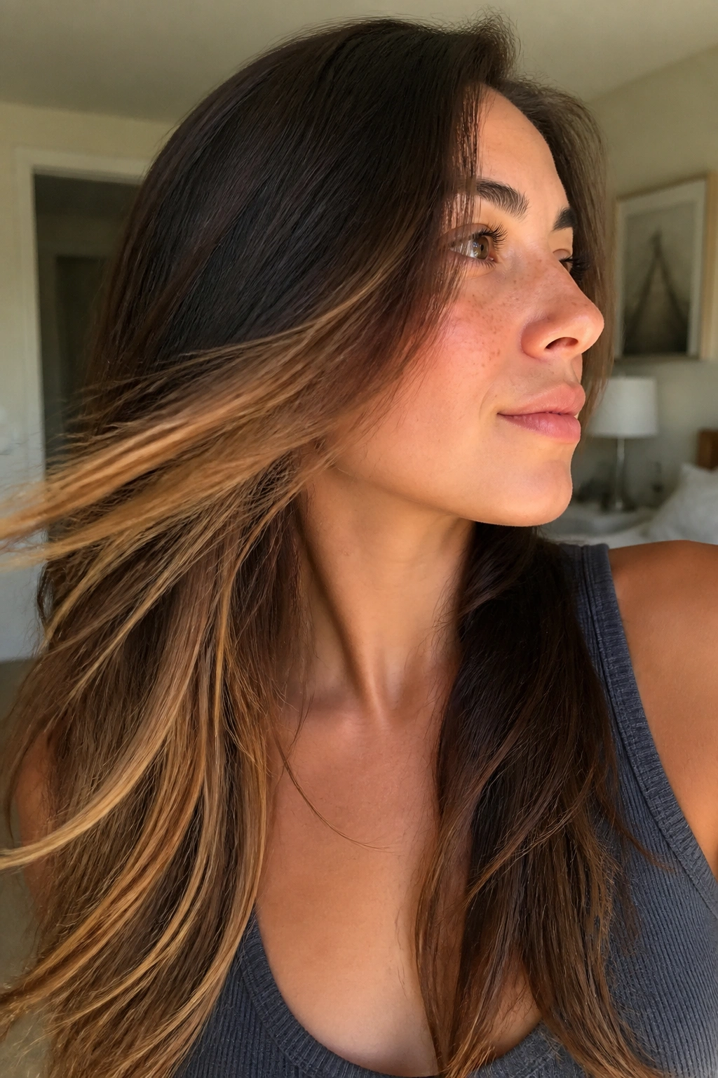Hair with honey underlayers peeking through beneath a darker top layer during movement