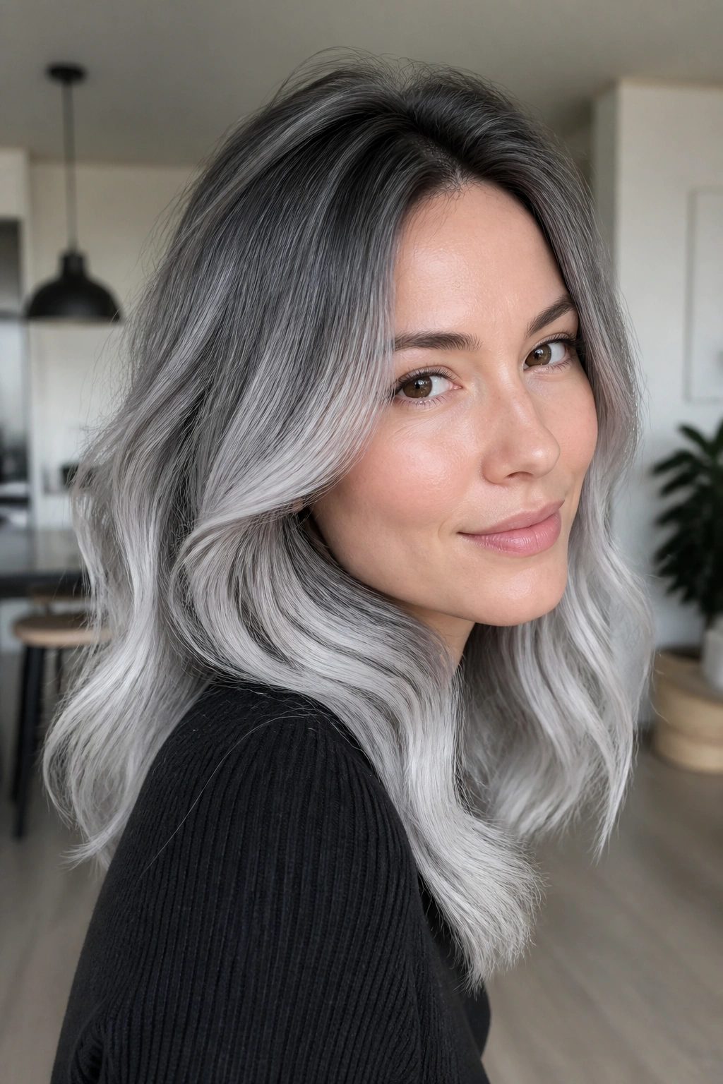 Portrait of a person with icy charcoal roots and silver ends hair