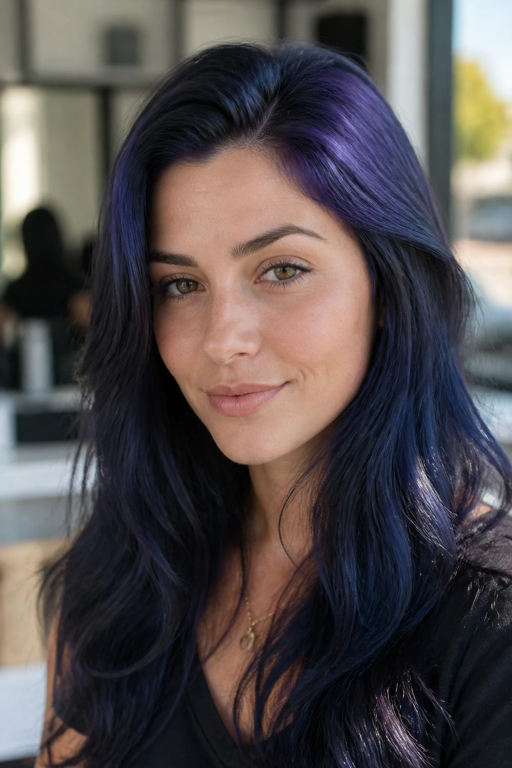 Close-up portrait of a woman with indigo roots hair.