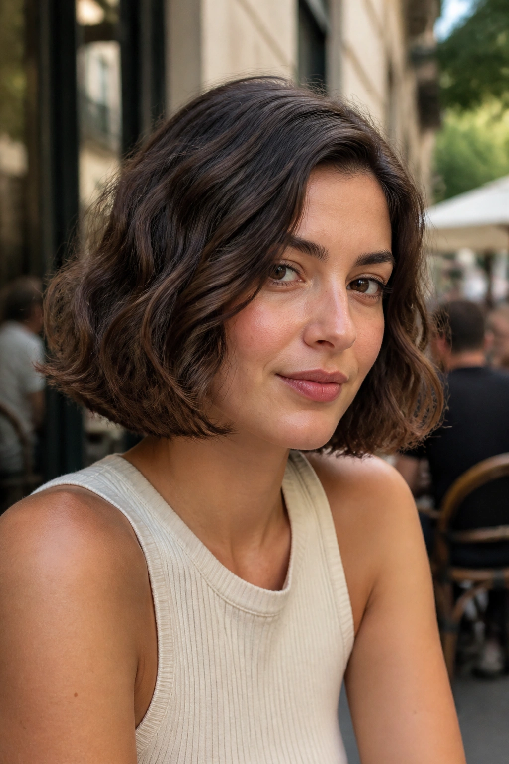 Portrait of a real woman with Italian bob for wavy hair, showing jaw-length cut and smooth waves.