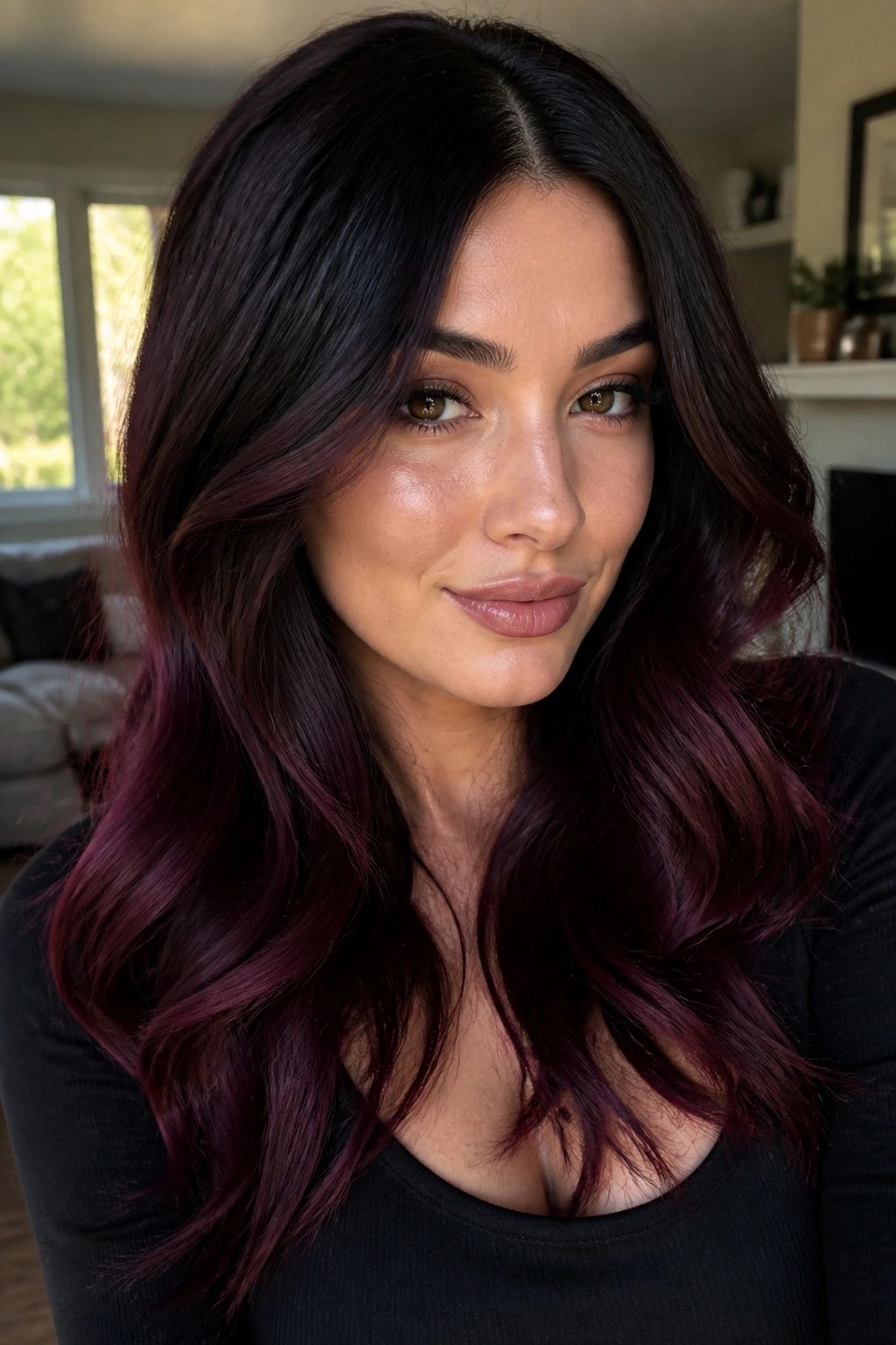 Close-up of a real woman with jet-black hair and burgundy gloss in loose waves