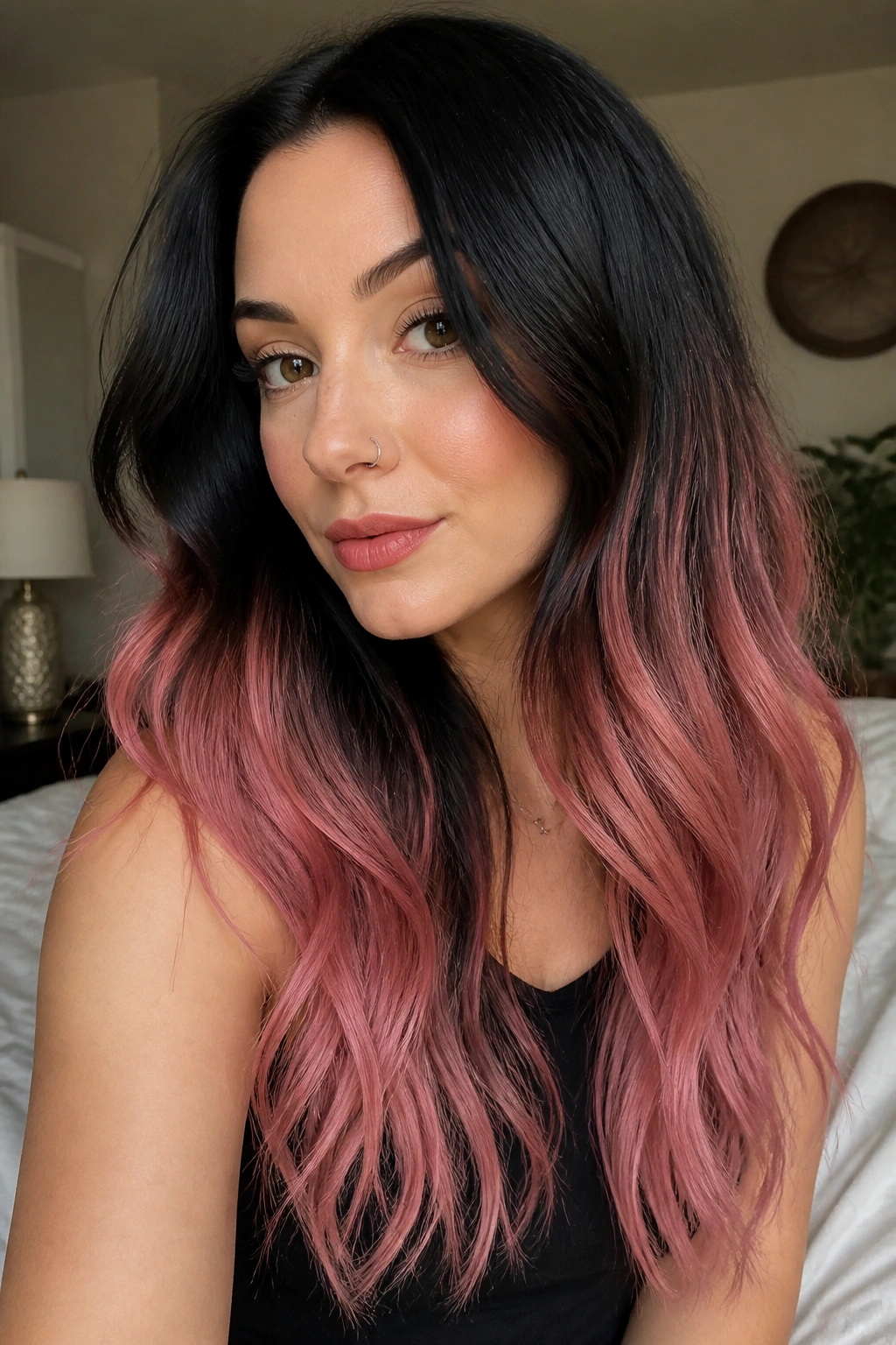 Close-up of jet-black roots fading to rose-petal pink ends on long ombre hair
