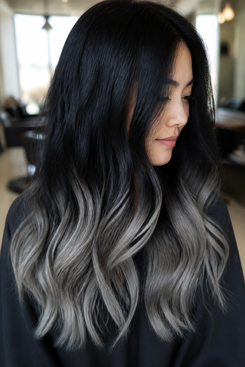 Close up portrait of a real woman with jet black to smoke gray dip dye on long hair