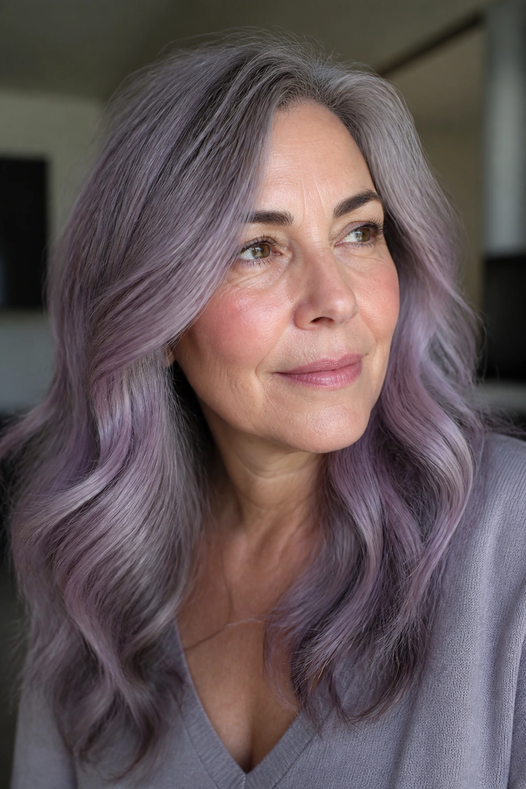 Portrait of a real woman with smoky lavender-gray hair and soft waves.