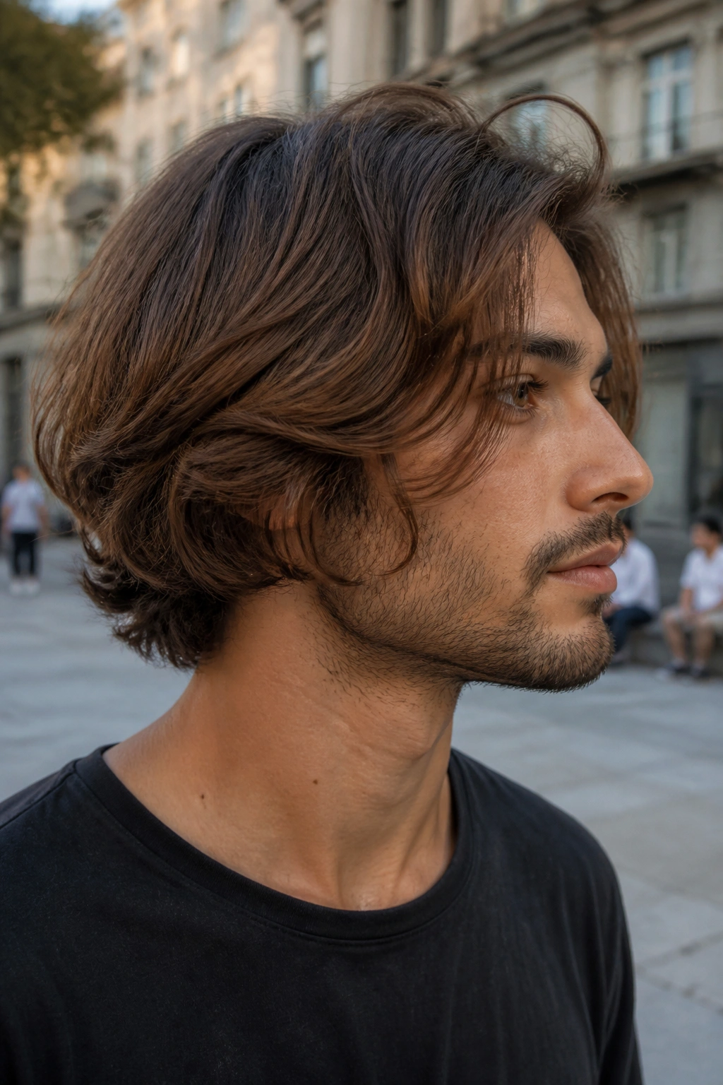 Close-up of a man with a layered bob showing movement in an outdoor setting
