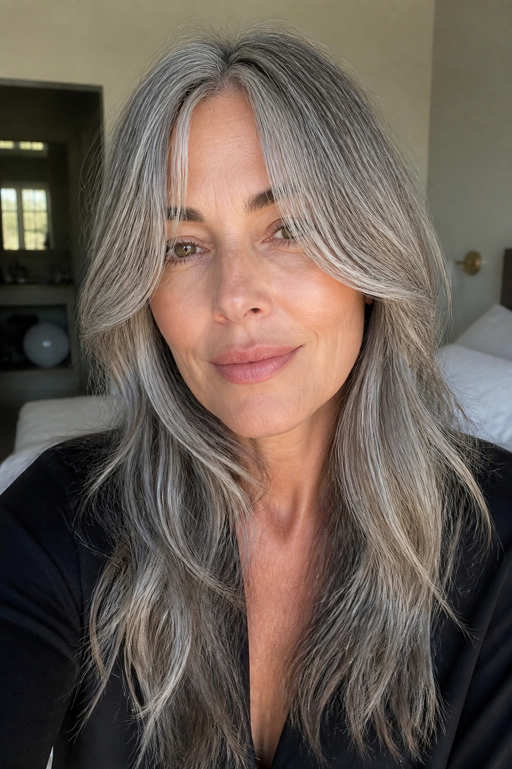 Close-up of a real person with long grey curtain bangs