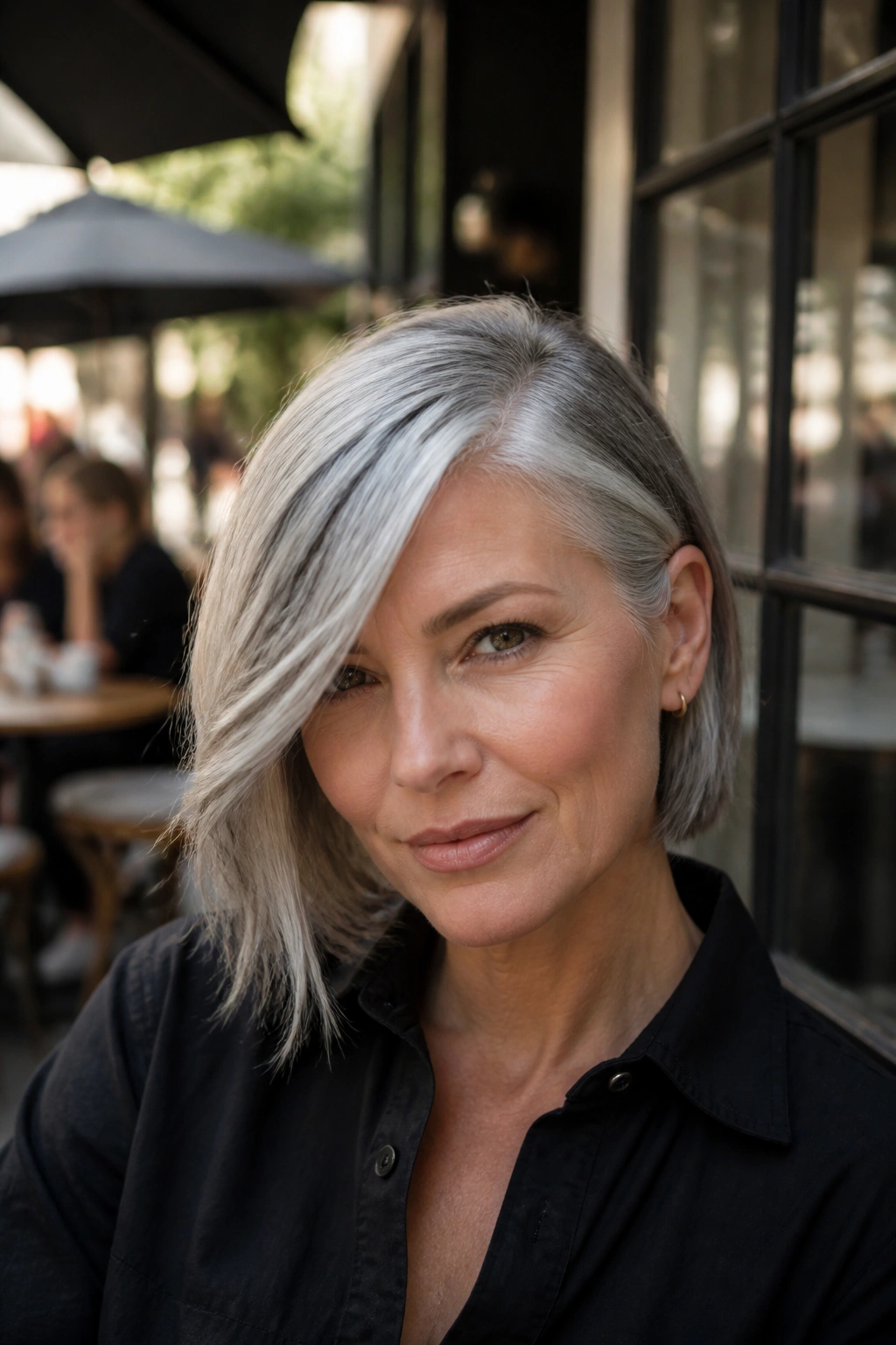 Close-up of a real person with long side fringe and a deep part in grey hair