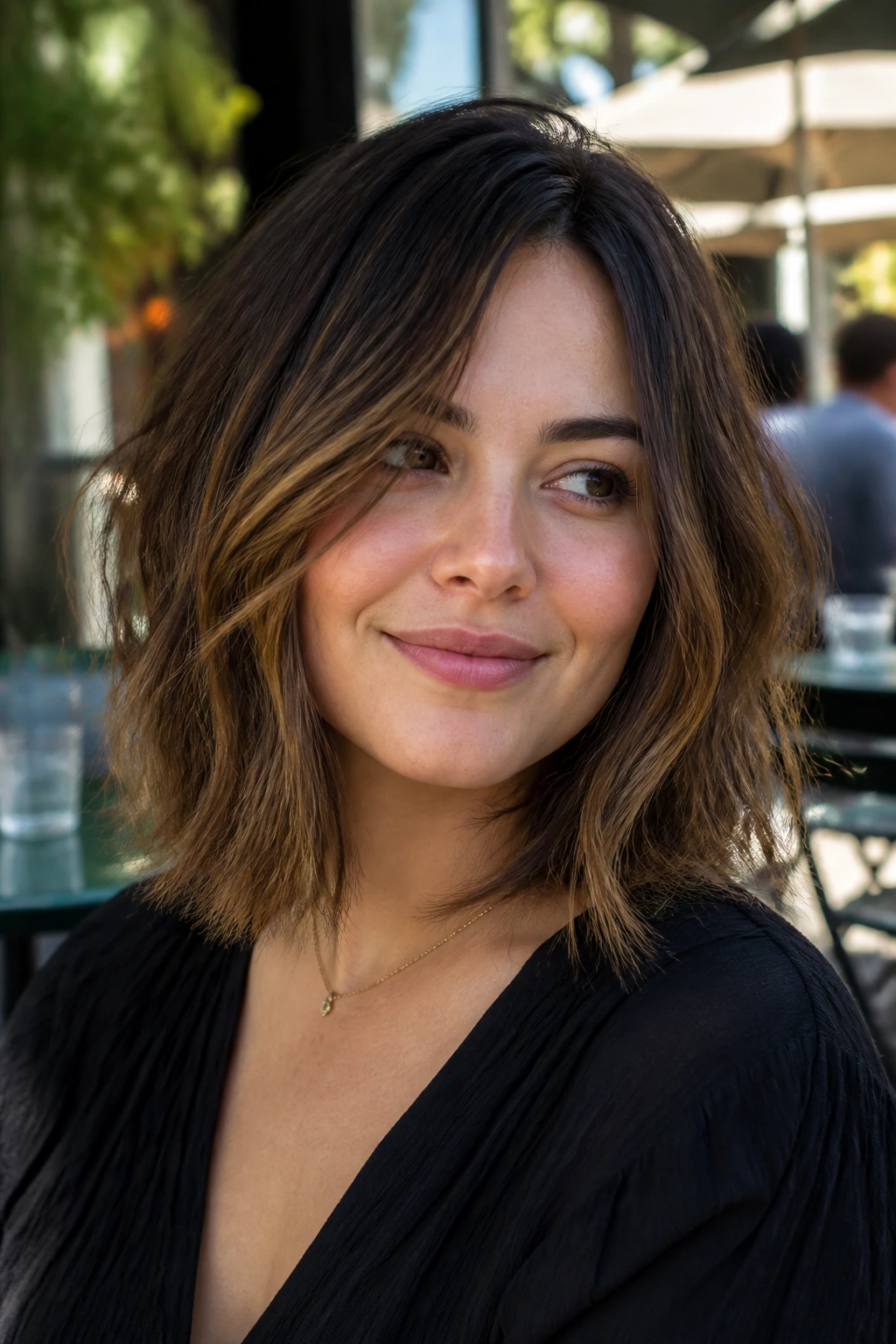 Close-up portrait of a real woman with a low-maintenance messy lob for round faces, off-center part and soft layers