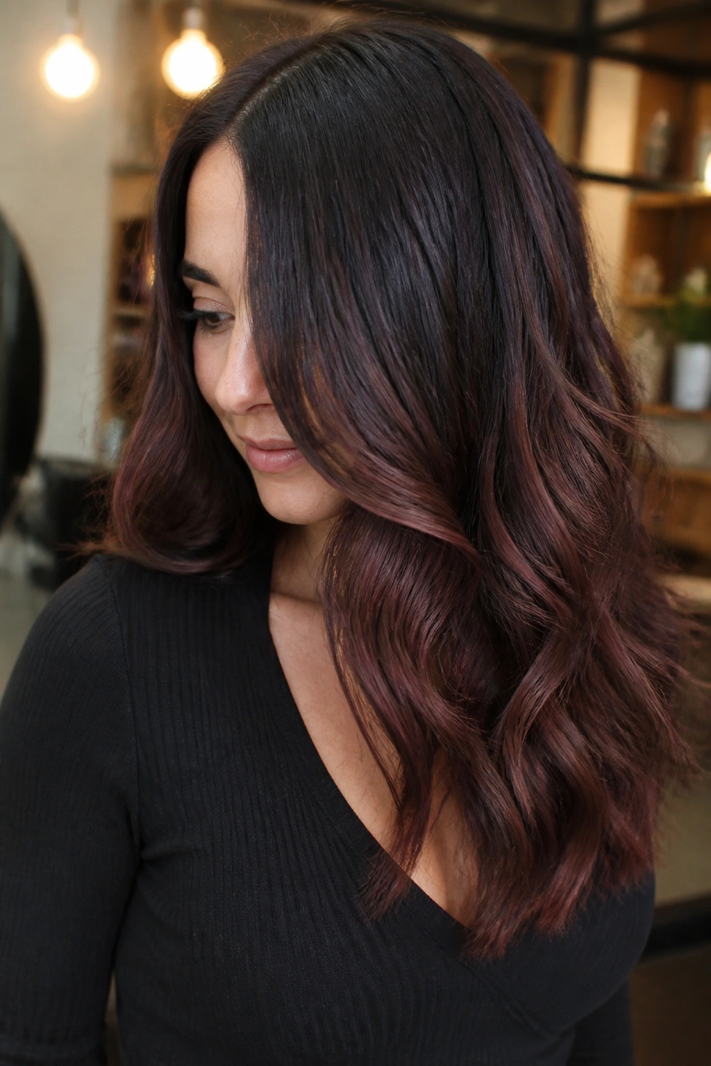 Close-up of a woman's dark brunette hair with mahogany balayage ribbons