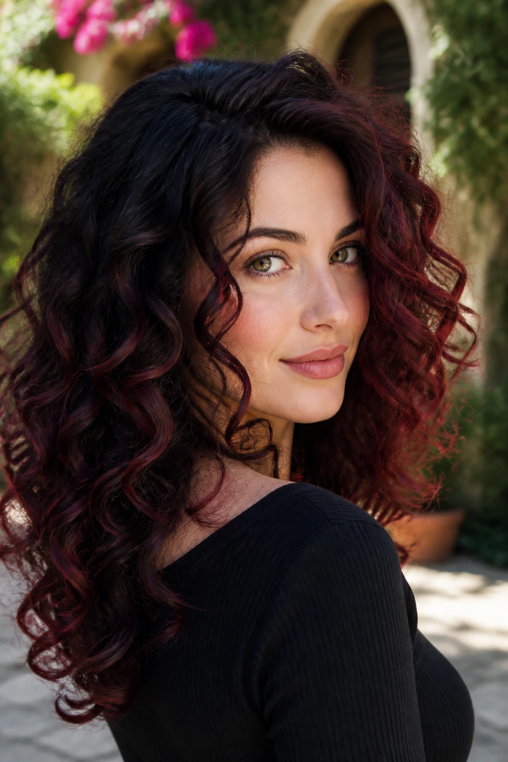 Close-up of curly hair with mahogany balayage on cool-toned skin.