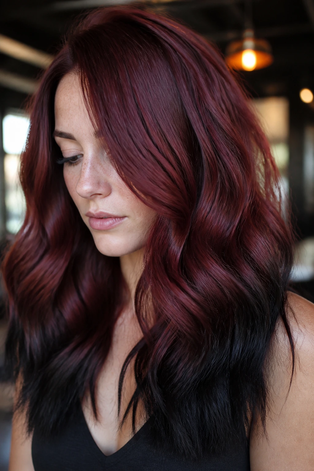Close-up of a real person with mahogany red hair and black-dipped ends