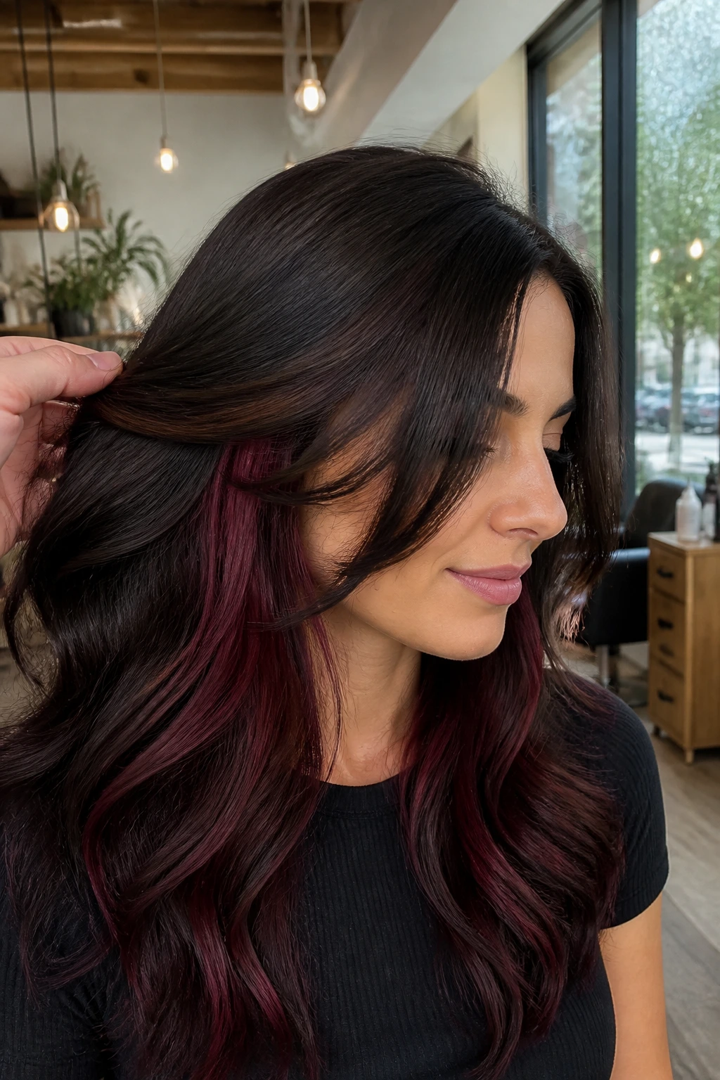 Close-up of a woman showing hidden mahogany underlights under brunette hair