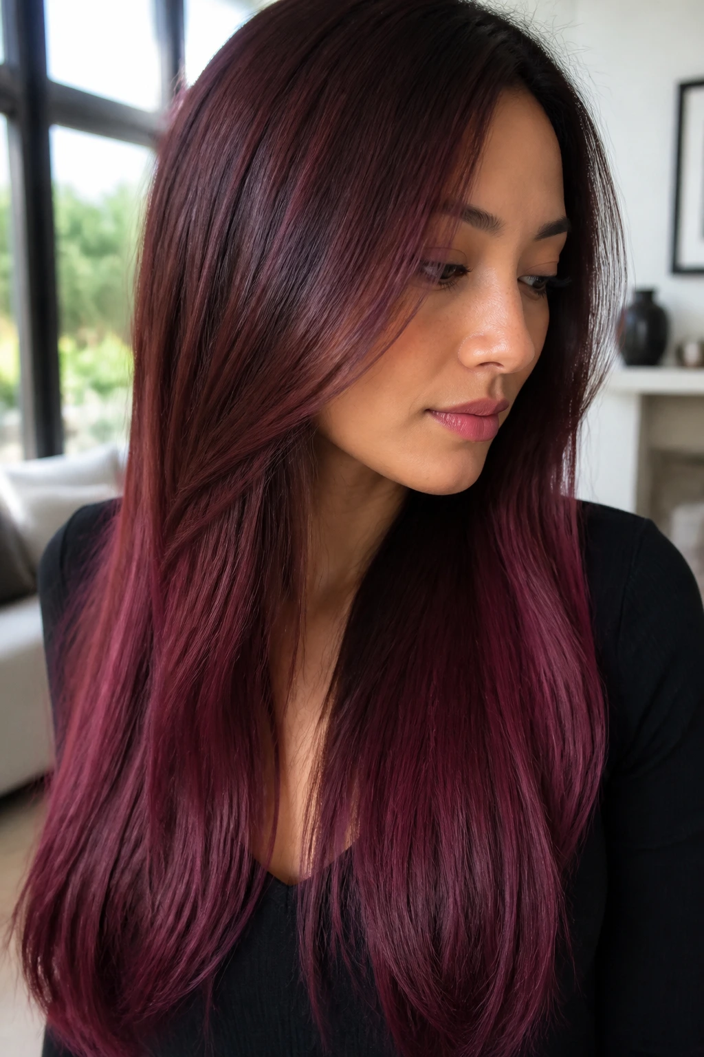 Close-up of long hair with a mahogany to wine gradient on a real person.
