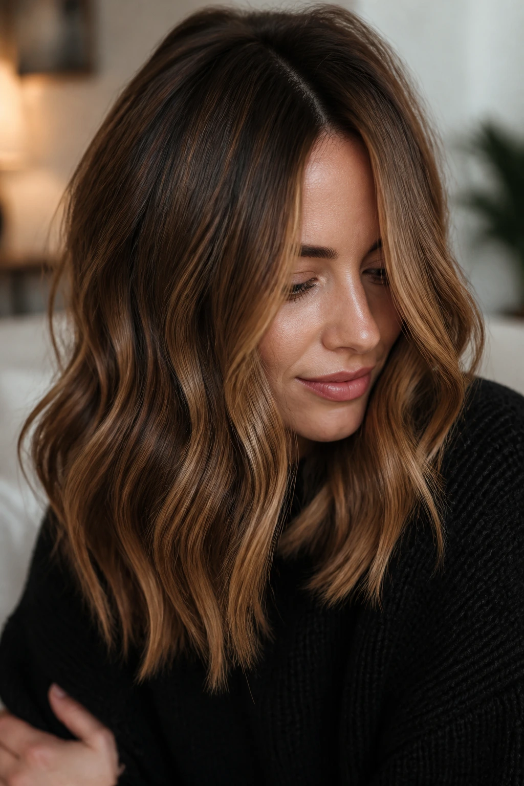 Close-up of real woman with maple brown hair and lived-in root shadow.