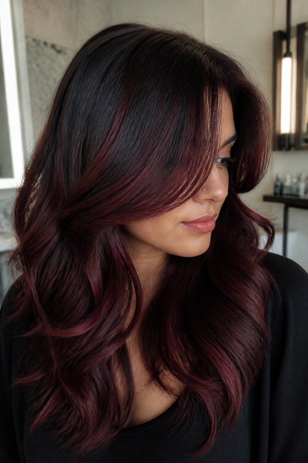 Close-up portrait of a real woman with dark chocolate hair and merlot balayage