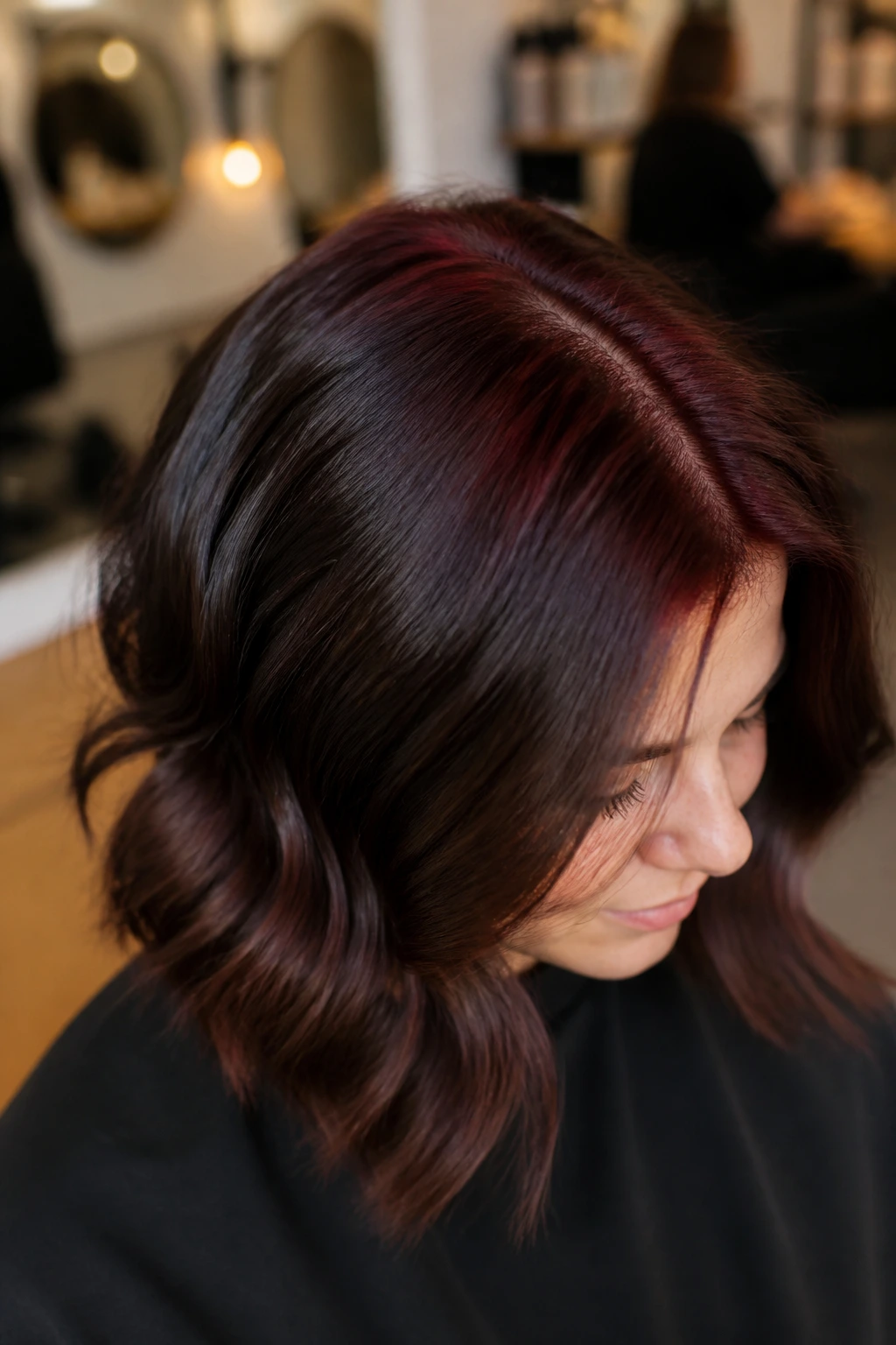 Portrait of a real woman highlighting a subtle merlot crown lowlight on brunette hair.