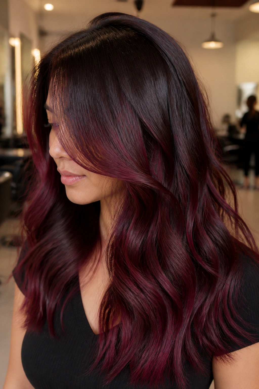 Close-up of long hair with a soft shadow root and merlot mid-lengths on a real person.