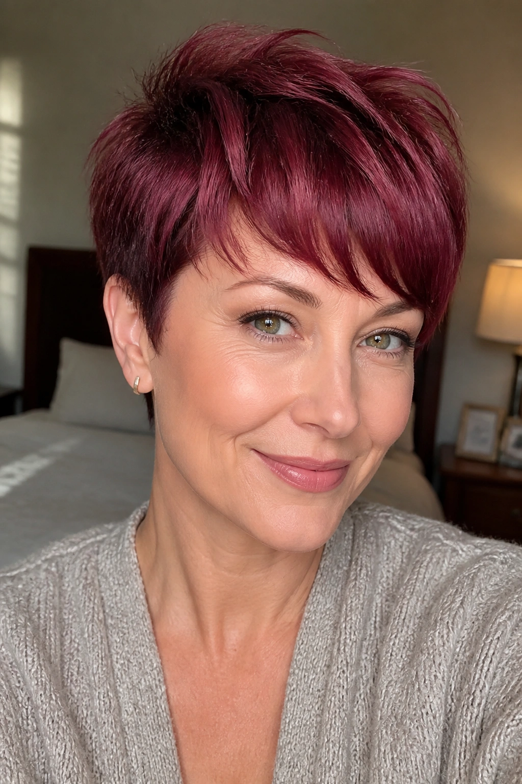 Real woman with merlot pixie and curved fringe.
