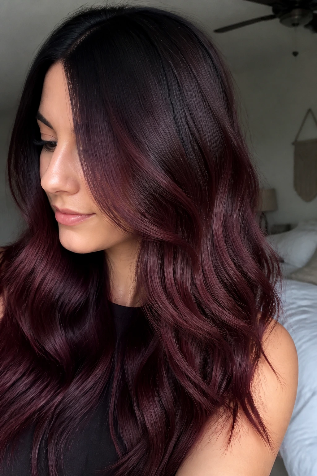 Long hair with merlot root melt and darker roots on a real person