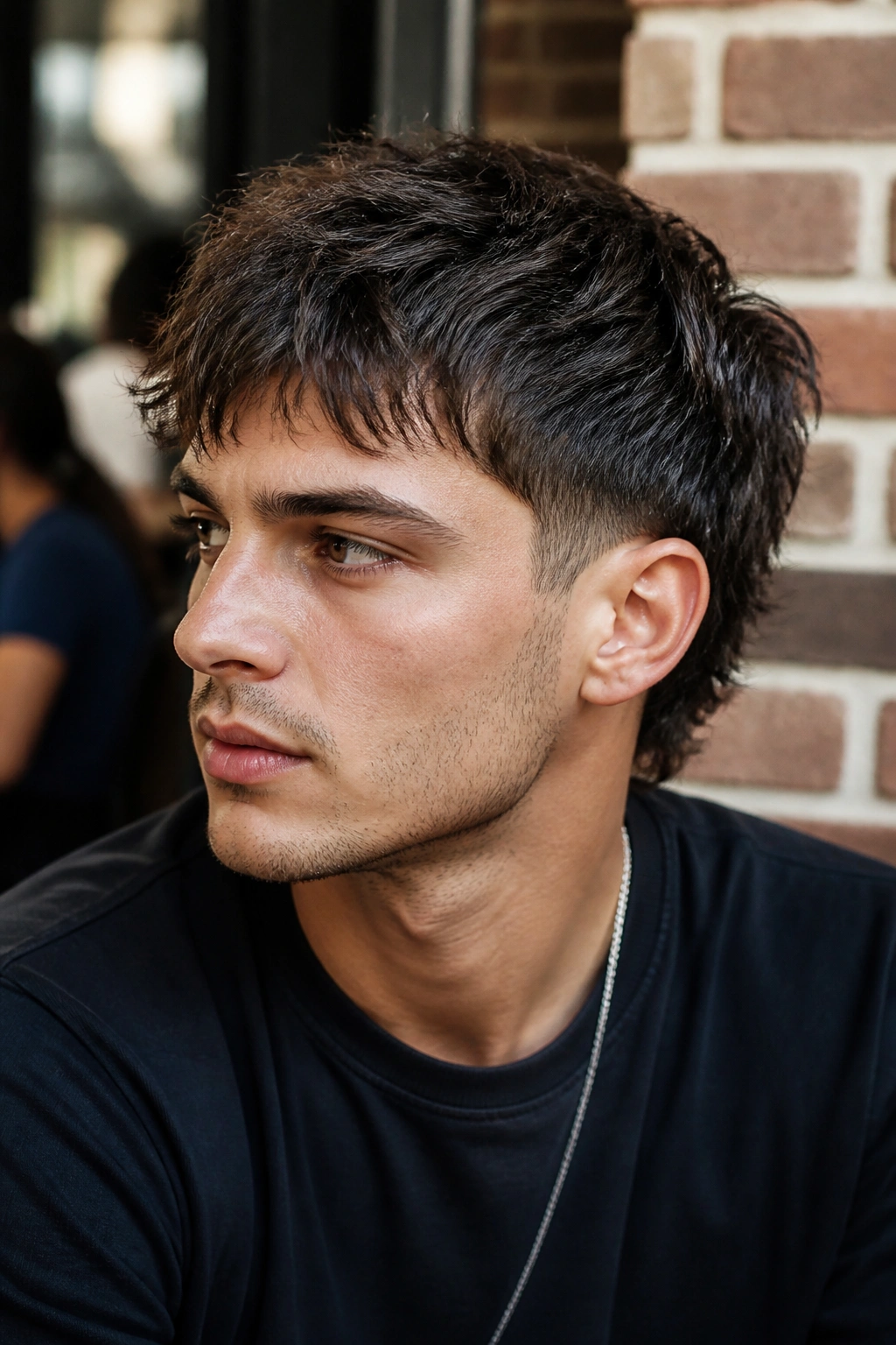 Close-up portrait of a man with a messy crop wolf cut, short top and choppy front.