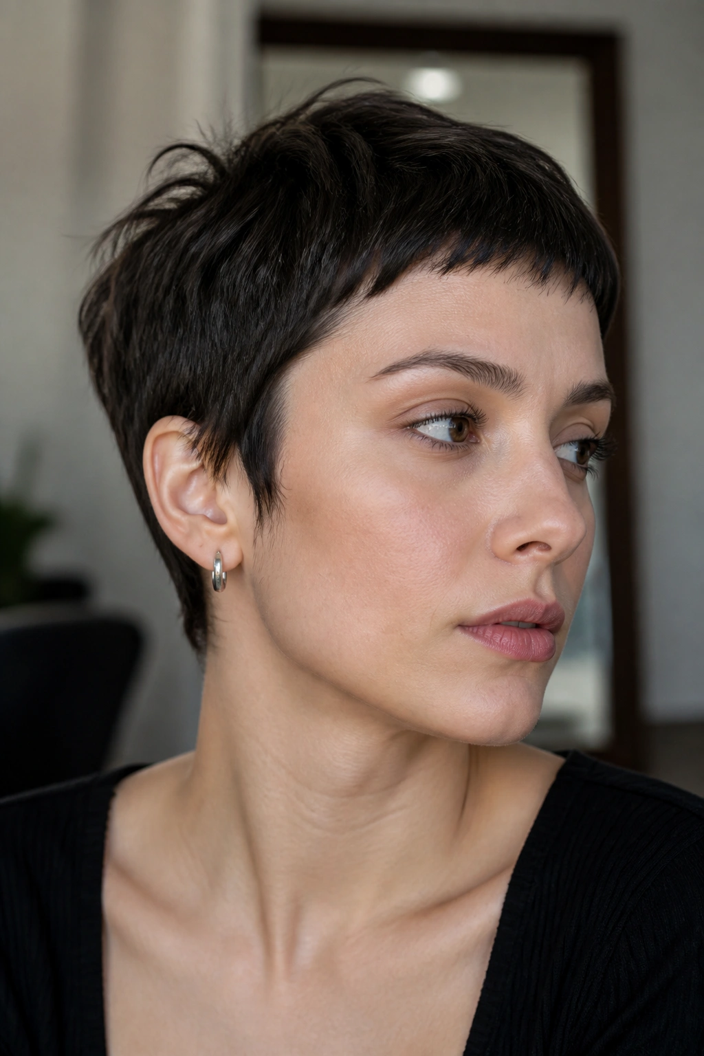 Close-up of real person with micro fringe on a textured pixie