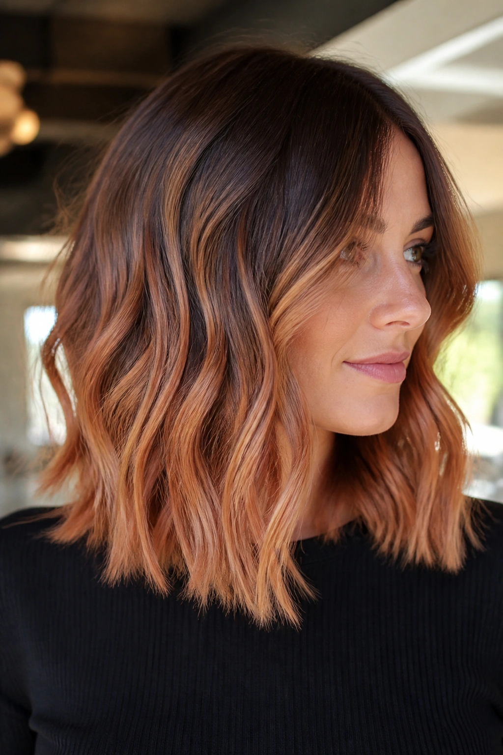 Shoulder-length brunette with a balayage melt from brown to copper to strawberry-gold