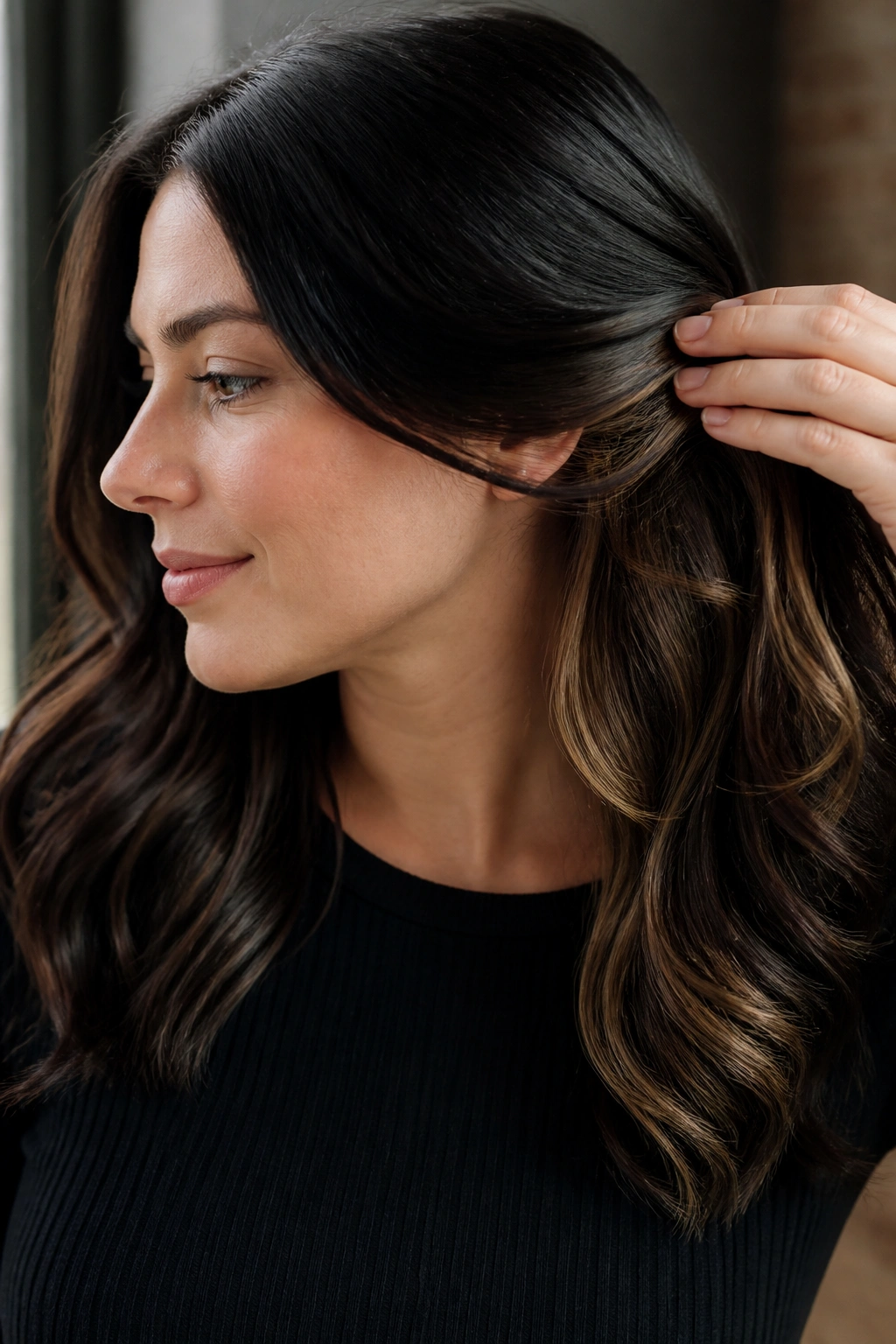 Close-up of midnight brown hair with hidden caramel underlights on a real person