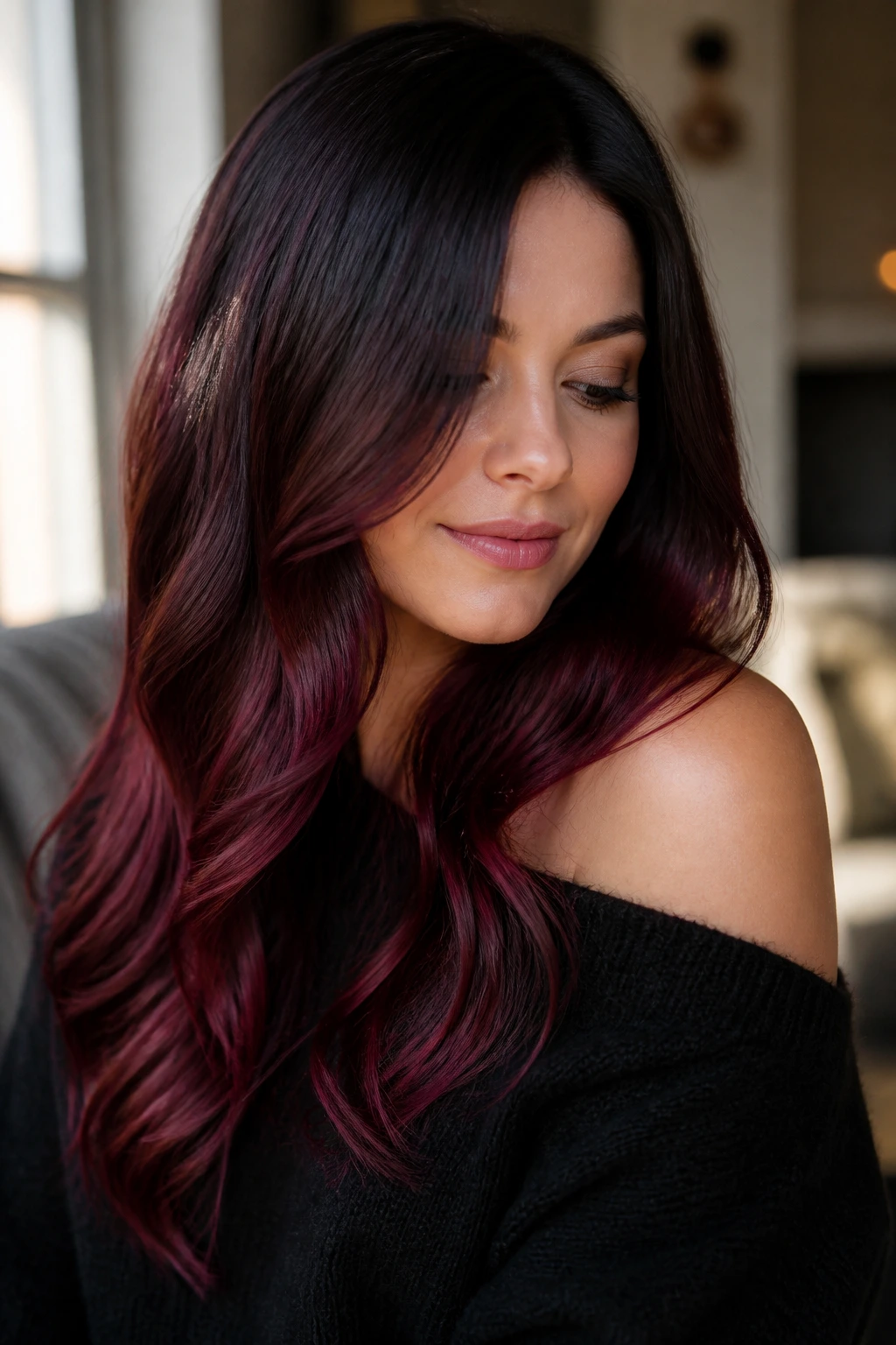 Close-up of a real woman with near-black roots fading to burgundy ends in a velvet melt.