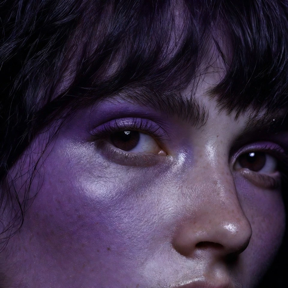 Close-up of a woman with near-black hair with violet sheen