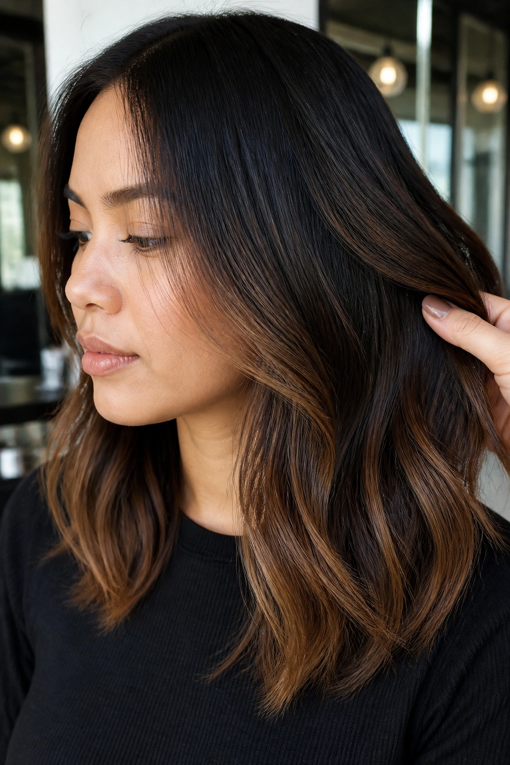 Close-up of a real woman showing mocha balayage starting below the eyes on shoulder-length hair