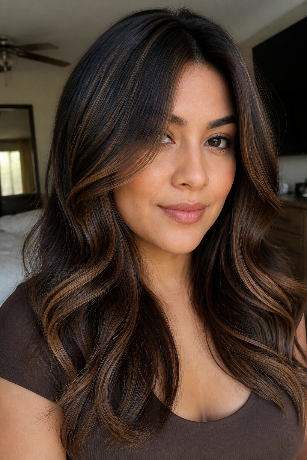Close-up portrait showing blended mocha-caramel dimension with low contrast on hair