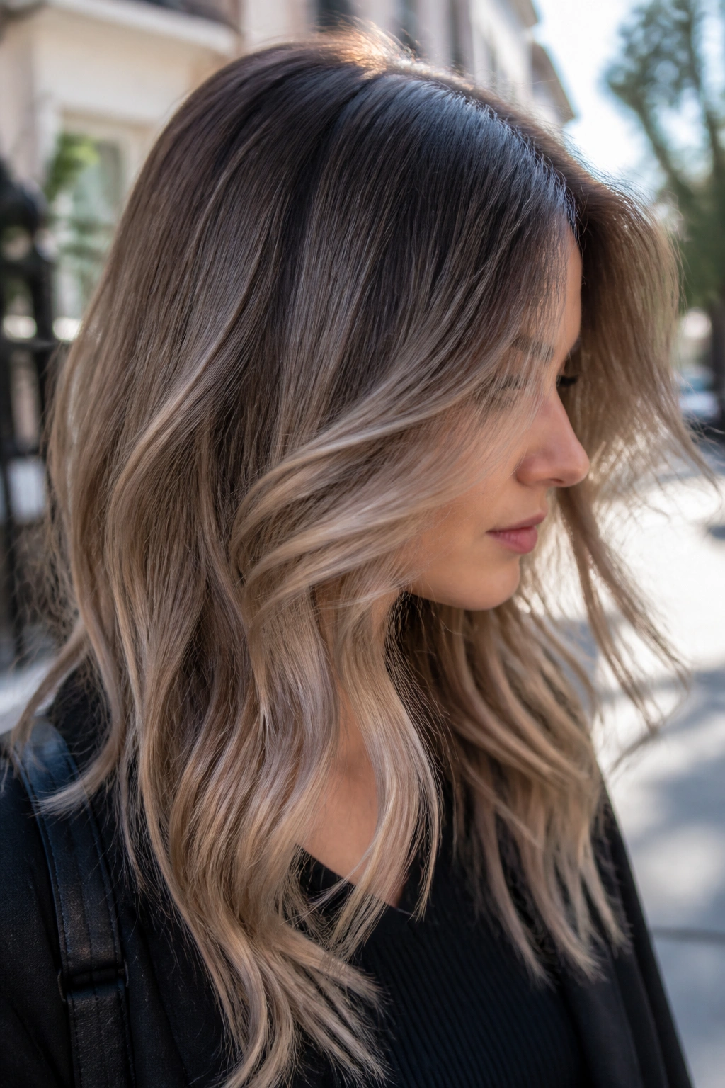 Moonlit beige balayage on real hair with silvery beige highlights against brunette base.