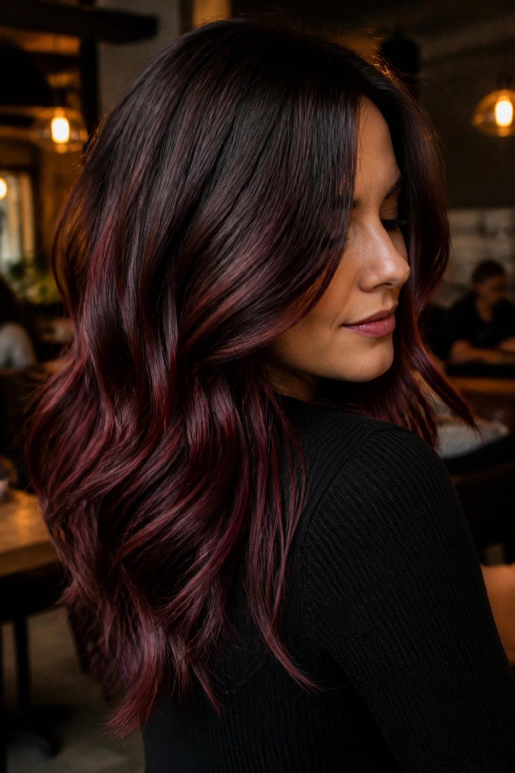 Close-up portrait of a real woman with mulled wine balayage, deep burgundy tones